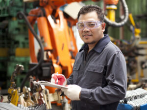 Man holding clipboard in industrial building