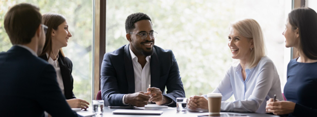 Woman sitting in front of computer cheering