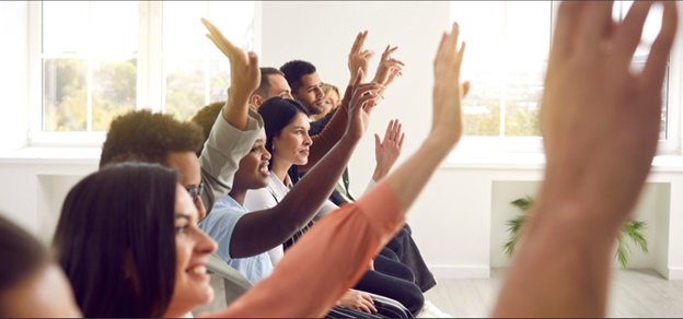 People cheering in front of a computer