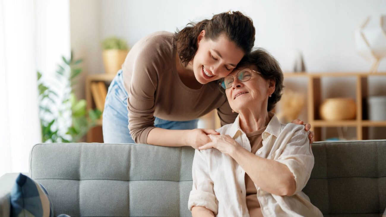 Daughter hugging her elderly mom.